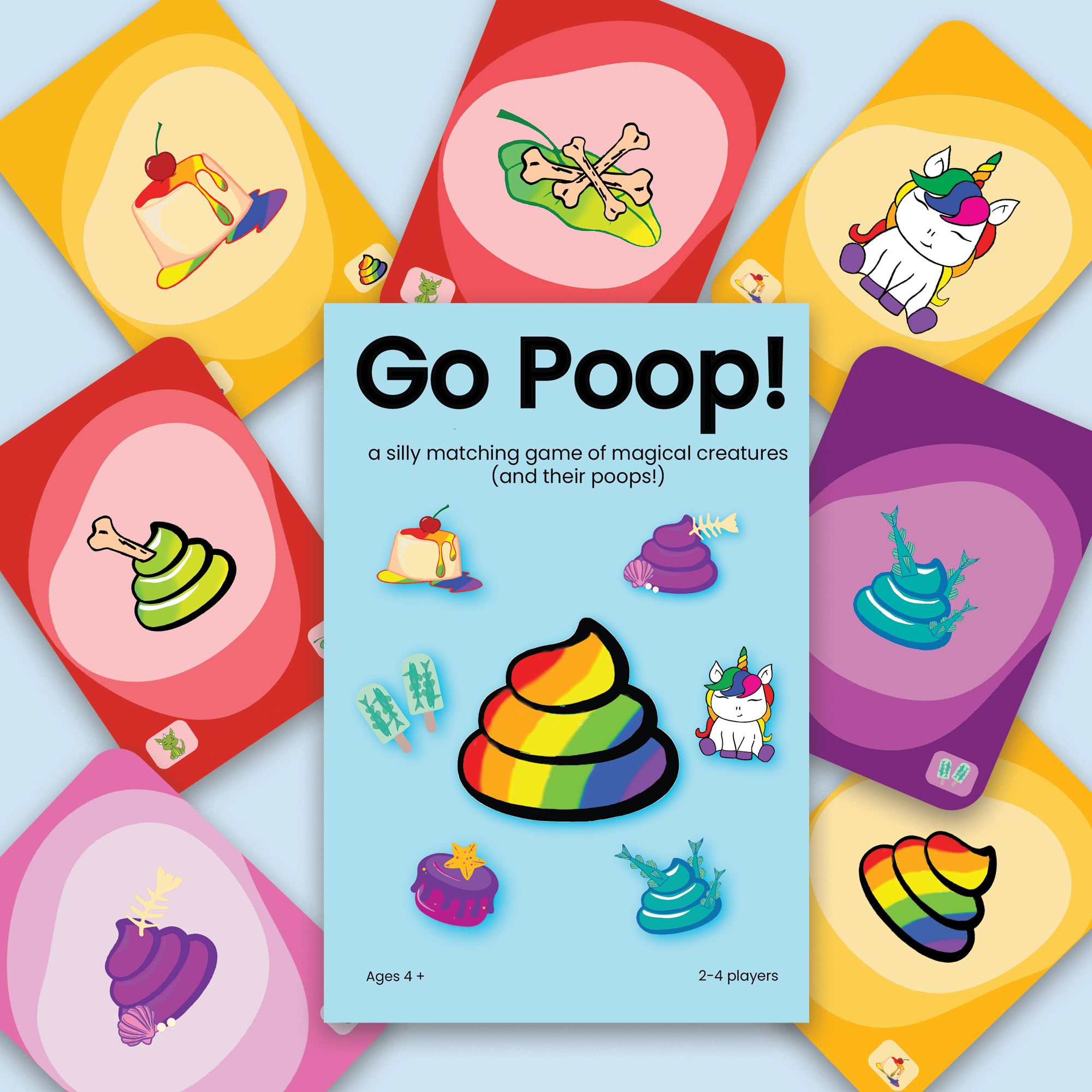 image of Go Poop! card box with cards scattered behind it, showing the unicorn and the poops and treats from the unicorn, dragon and others